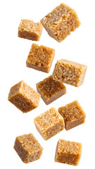 Brown sugar cubes falling on transparent background with realistic texture and natural lighting