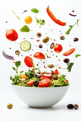 Fresh salad ingredients in mid-air above a bowl of salad