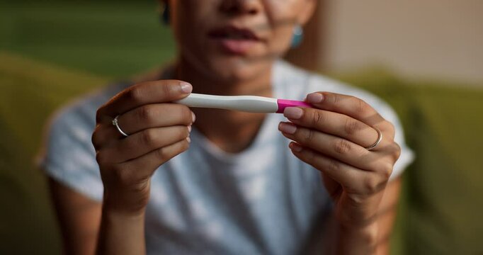Hands, woman and nervous with pregnancy test, anxiety or disappointed with negative results or IVF fail at home. Stress, worry and ovulation stick with bad news for person upset with infertility