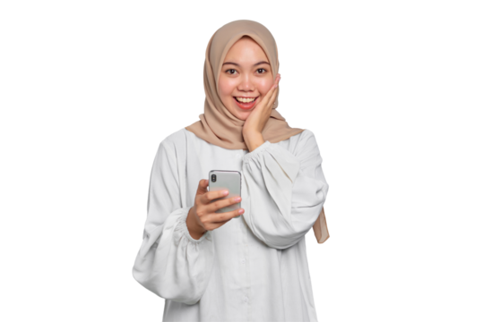 Smiling young Asian Muslim woman using a mobile phone and looking at camera isolated on transparent background