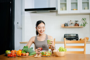 Woman Preparing Healthy Meal in Kitchen, Fit Woman Making Smoothie and salad with Fresh Ingredients at home. Active healthy lifestyle, clean eating concept