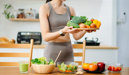 Woman Preparing Healthy Meal in Kitchen, Fit Woman Making Smoothie and salad with Fresh Ingredients at home. Active healthy lifestyle, clean eating concept