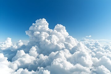 A breathtaking aerial view of a vast expanse of fluffy cumulus clouds against a vibrant blue sky