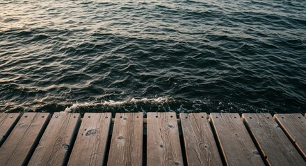 Fototapeta premium Dark Blue Water Waves on Wooden Dock at Sunset