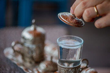 Traditional Turkish Copper Coffee Cup on Ancient Stone, Lid Opening