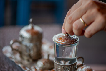 Traditional Turkish Copper Coffee Cup on Ancient Stone, Lid Opening