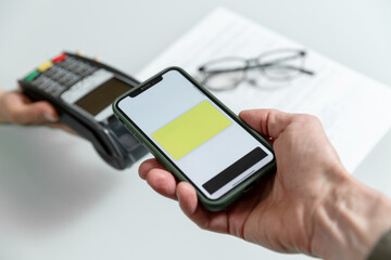 Hands using pos terminal  and smart phone to complete nfc payment, financinal operation.