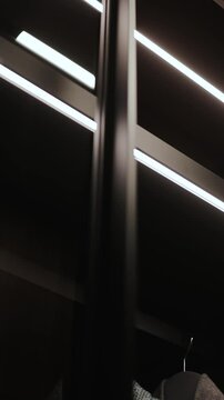Vertical video. Modern Shelving Featuring Integrated Lighting in a Stylish and Elegant Interior Space