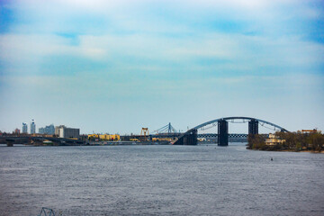 Scenic View of the Bridge Over the Water with the Cityscape in the Background on a Sunny Day