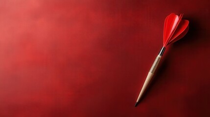 An artistic depiction of a red dart resting on a vibrant red background, symbolizing precision, focus, and the pursuit of goals and aspirations.