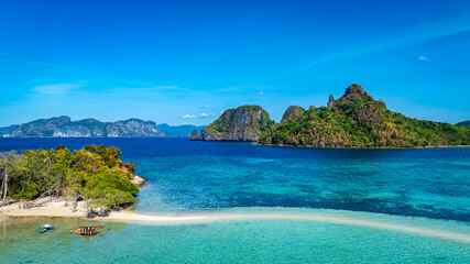 Aerail view of  tropical exotic island sand bar separating sea in two with turquoise  in El Nido, Palawan, Philippines.