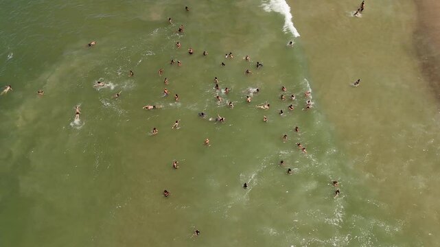Gathered people at the sea to celebrate festival of Yemanja, aerial drone shot static