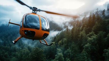 An orange helicopter hovers gracefully above a dense, fog-covered forest, showcasing an adventurous spirit, exploration, and the beauty of nature from above.