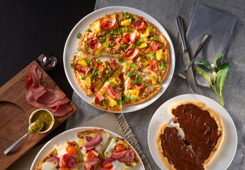 Pizzen Hauptspeise und Dessertpizza mit Schokolade als Topshot auf gedecktem Tisch, Pizza, schinken, Gemüse, 