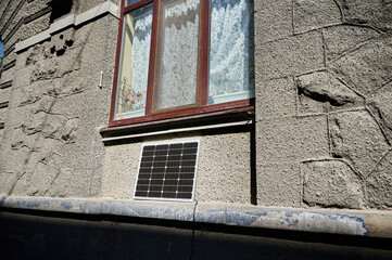 Photovoltaic solar panel in front of historical building. Concept of integration of sustainable...