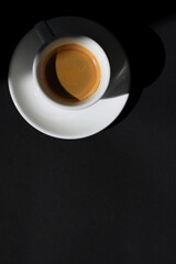 Coffee. Top Down View of Cup of Fresh Espresso on Black Background.