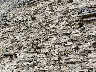 An ancient wall of stone, ruined ancient wall of brick.