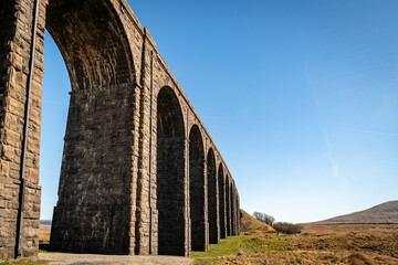 A sunny spring HDR image of the eastern half of the Ribblehead Viaduct, from the south, showing the...