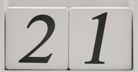 Close-up of the number 21 displayed on white blocks. Ideal for concepts related to numbers, dates, and simple design. Number 21 on White Background - Simple Numeric Representation
