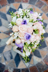 Beautiful Floral Bouquet Featuring Pale Pink Roses and Lilac Accents on Decorative Tile.