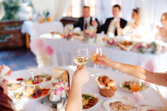 Elegant Wedding Celebration with Guests Toasting at Reception.. - Powered by Adobe