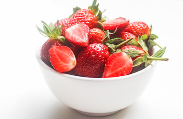 strawberries in a bowl isolated on white background