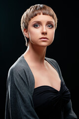 Fototapeta premium Portrait of a Woman with a Modern Hairstyle and Elegant Expression..