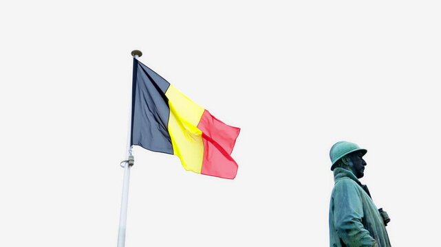 Arlon, Belgium - April 13, 2025: Soldier statue stands before a church, featuring the Belgian flag, representing heritage and remembrance in Belgium