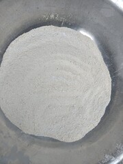 close-up view of a mound of white flour in a gray bowl