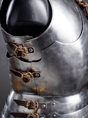 Close-Up of Medieval Steel Armor Suit with Decorative Leather Straps and Buckles..