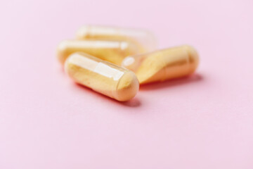 Coenzyme Q10 capsules. Antioxidants. Concept for a healthy dietary supplementation. Bright background. Soft focus. Close up. Copy space.	