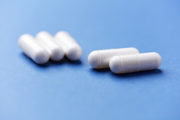 Arginine capsules on bright background. Soft focus. Close up. Copy space.	