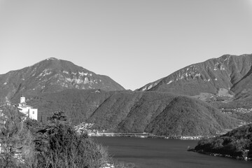 Church of Saints Fedele and Simone and Lake Lugano with Mountain in a Sunny Day in Vico Morcote, Ticino, Switzerland.
