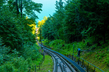 Railroad Track in the Forest on Mountain Side and Lake Lucerne in a Sunny Day in Burgenstock, Nidwalden in Switzerland.