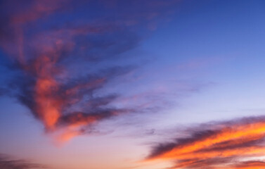 Fototapeta premium Stunning dramatic sunset sky background with orange purple clouds and pink and red firmament texture