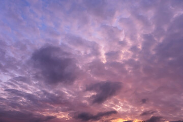 Fototapeta premium Stunning dramatic sunset background with lilac purple clouds and blue sky firmament texture