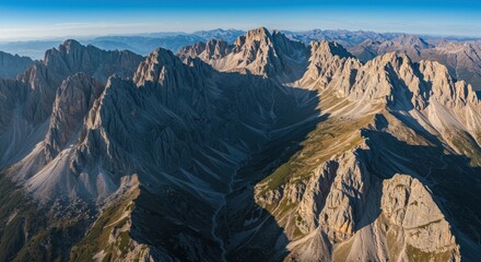 Obraz premium Sunny daytime mountain landscape with striking shadows, showcasing the natural beauty and contours of the terrain.