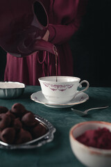 Pouring Hot Chocolate into a Teacup with Rich Texture and Elegant Atmosphere