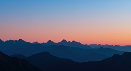 Fototapeta premium Sunrise view from the top of a hill with soft morning fog and warm golden light spreading across the landscape.