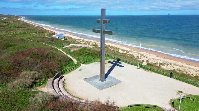 Cross of Lorraine, monument overlooking Juno Beach on Graye-sur-Mer, historic site and symbol with free France. Aerial drone orbiting