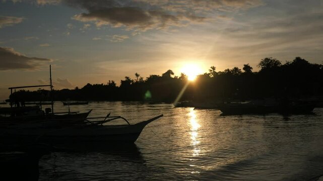 Traditional Bangka Boats Anchored at the Beach in Bantayan Island in the Evening During Sunset, Cebu, Philippines