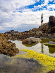 Faro de Favaritx en Menorca con reflejos en el amanecer