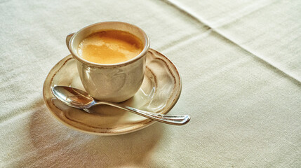After Lunch Ceramic Cup of Coffee on Table with Tablecloth