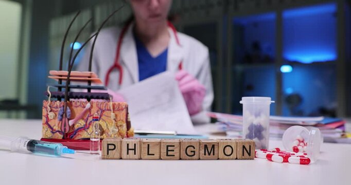 A healthcare professional reviews medical documents on phlegmon and related treatment tools in a clinical setting