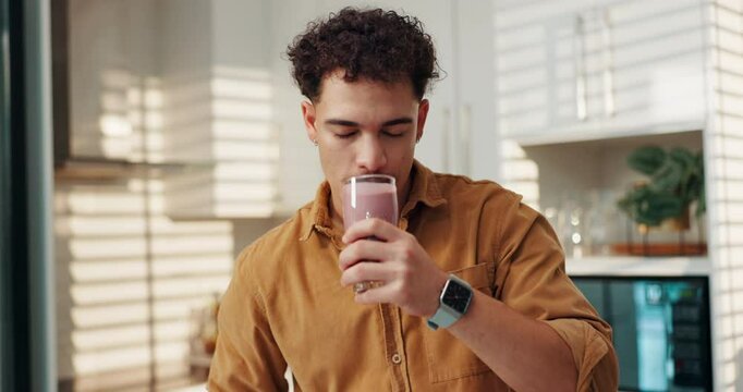 Smoothie, drinking and man in kitchen with blender, glass and pouring beverage for gut health. Series, male nutritionist and fresh ingredients in home for detox diet, protein shake enjoy flavor