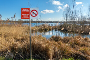 Warning sign (in Dutch) not to swim because of poisonnous blue-green algae in artificial lake Klinkenberger