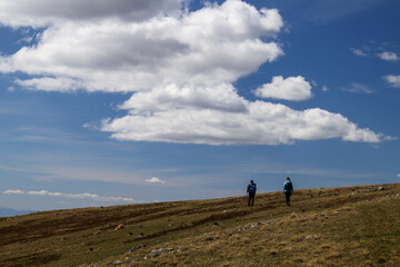 Hikers Embracing Nature in Majestic Mountain Landscape