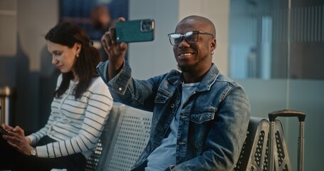 Crowded International Airport Terminal: African American Travel Blogger Filming Video Content from...