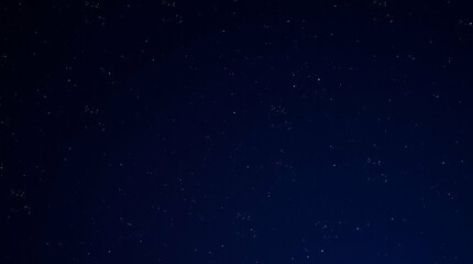 Nightscape: A captivating view of a star-studded sky in deep blue hues