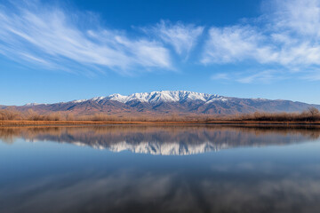 Fototapeta premium Stunning lake reflection showcasing mountains with mirrored beauty during a calm day in nature